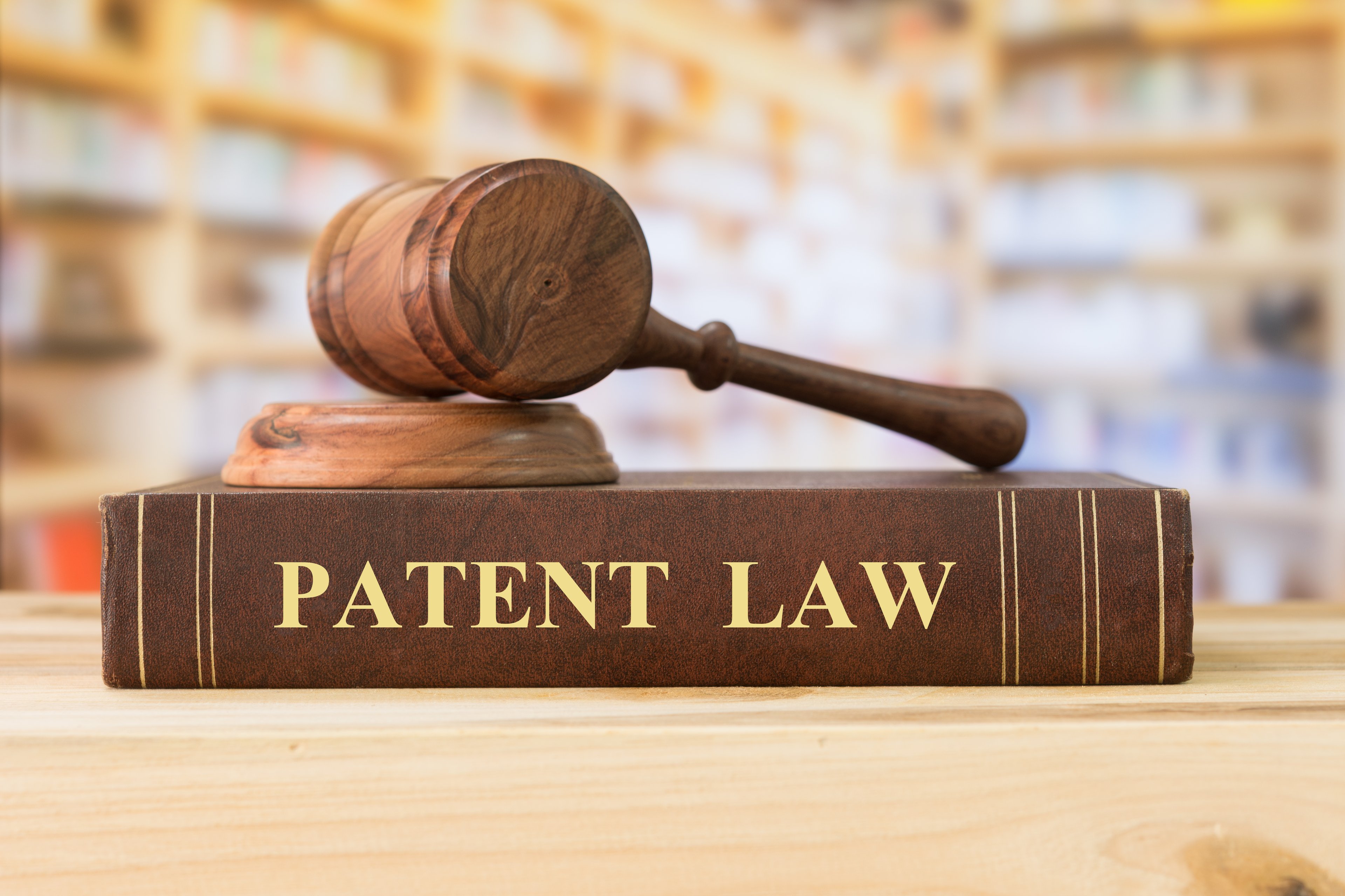 A gavel sitting on top of a book titled "Patent Law."