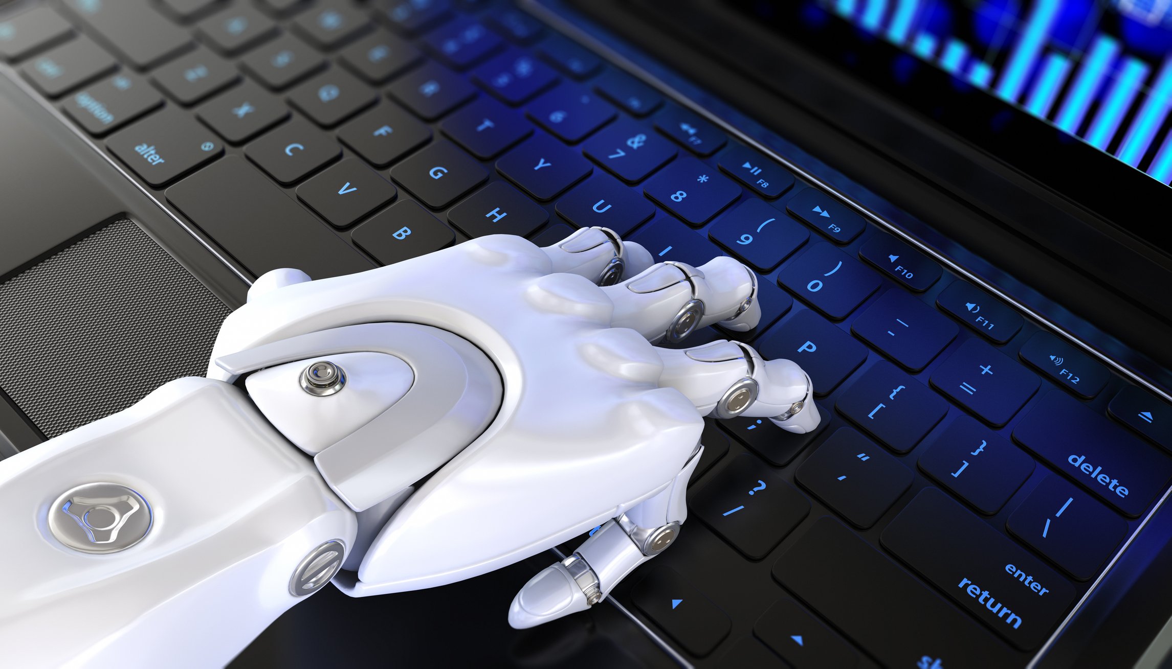 A robot hand on a laptop keyboard.