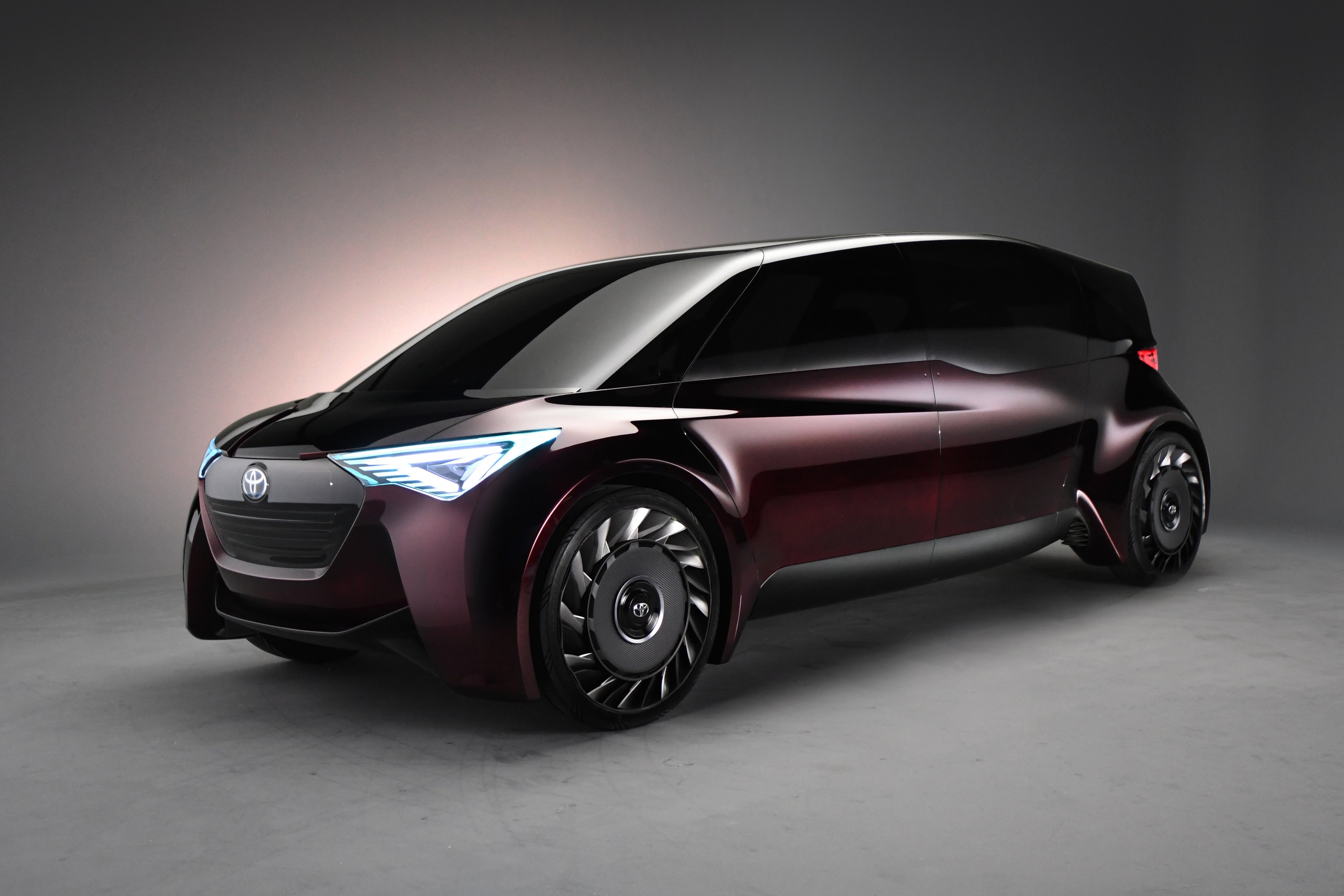 Toyota's Fine-Comfort Ride concept vehicle, a boxy purple four-door shaped somewhat like a minivan.