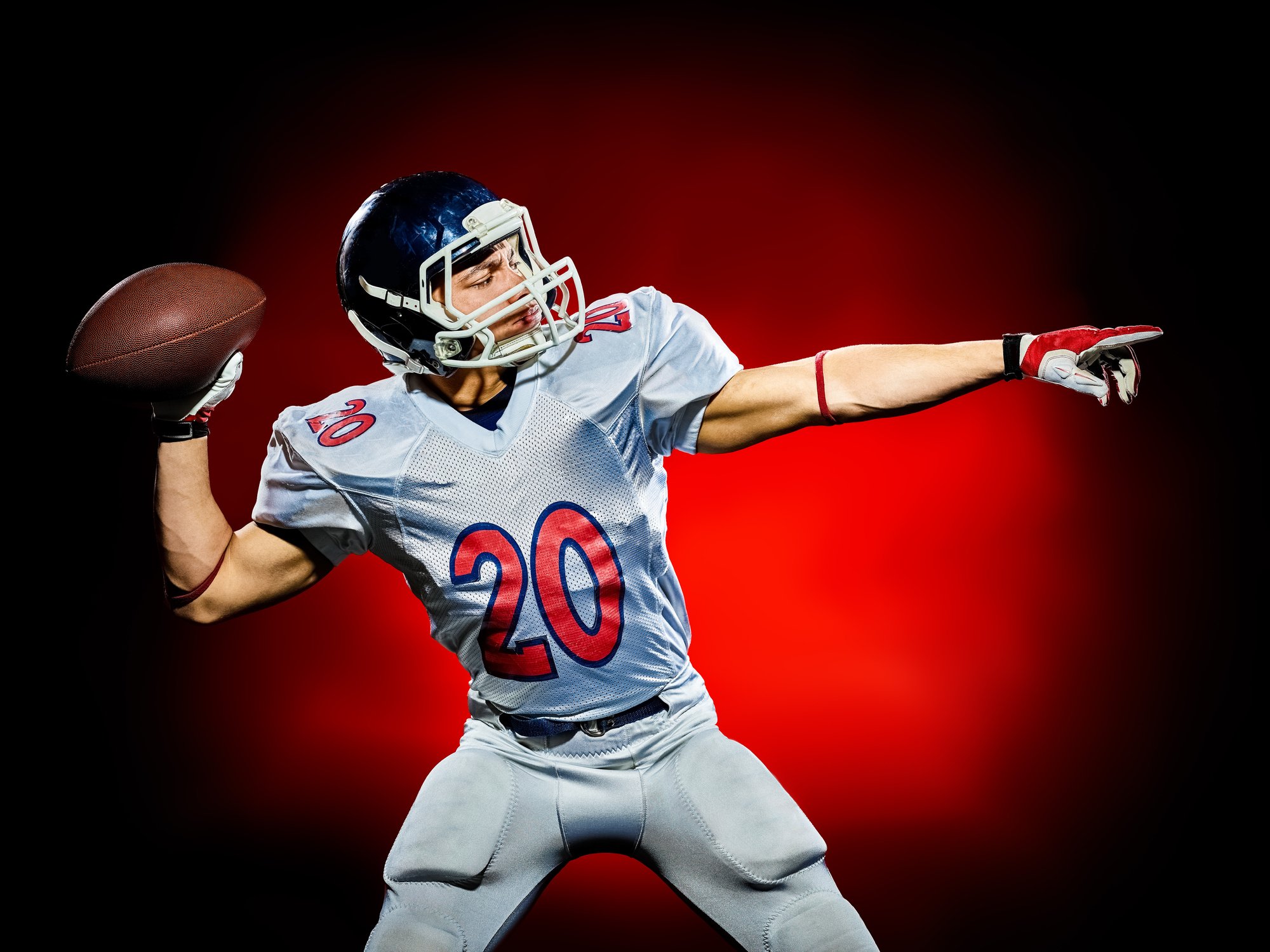 A football player throwing a football.