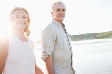 Retired couple walking on the beach