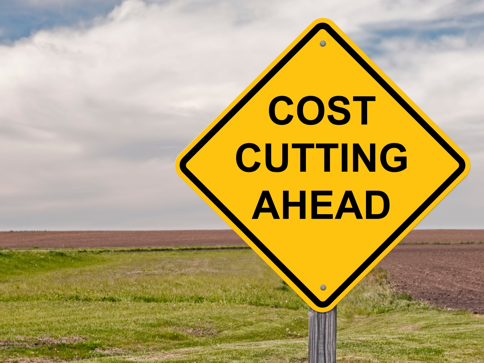 A road sign that says "Cost Cutting Ahead."