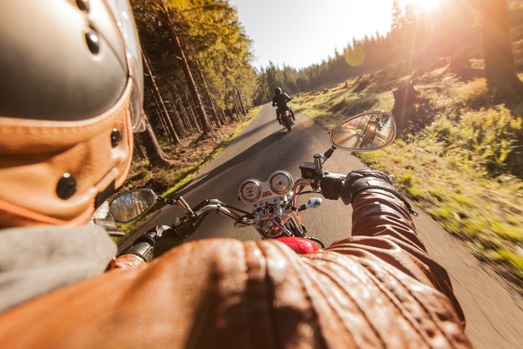 Man riding a motorcycle through the countryside