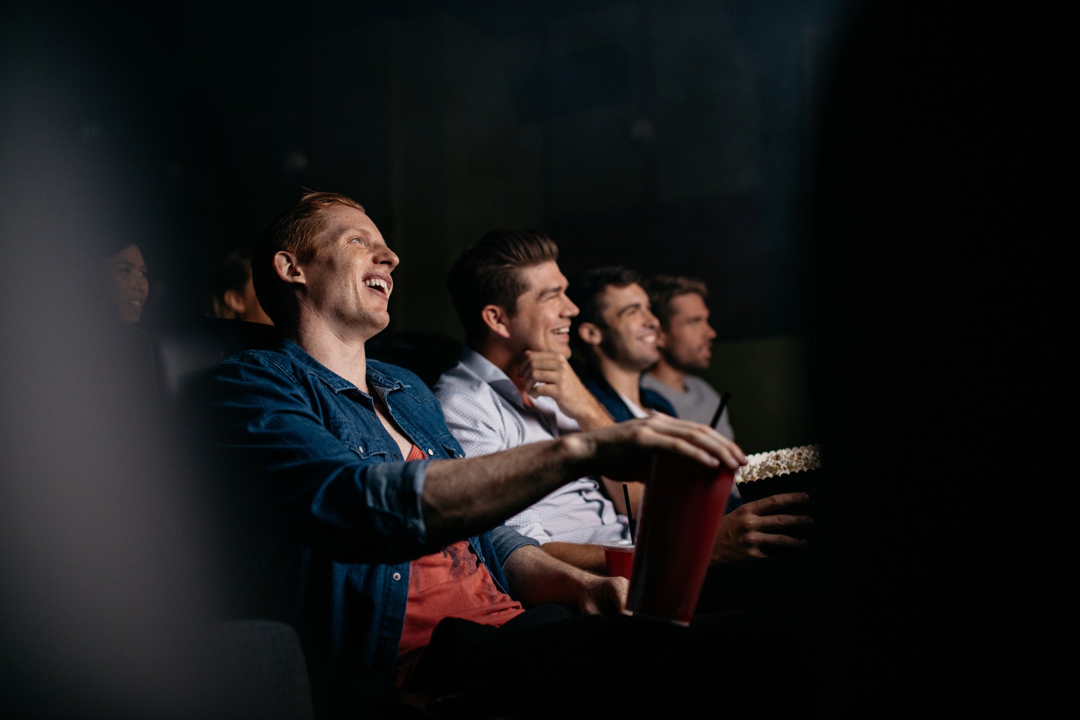 A group of people watching a movie in a theater