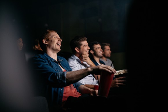 A group of people watching a movie in a theater
