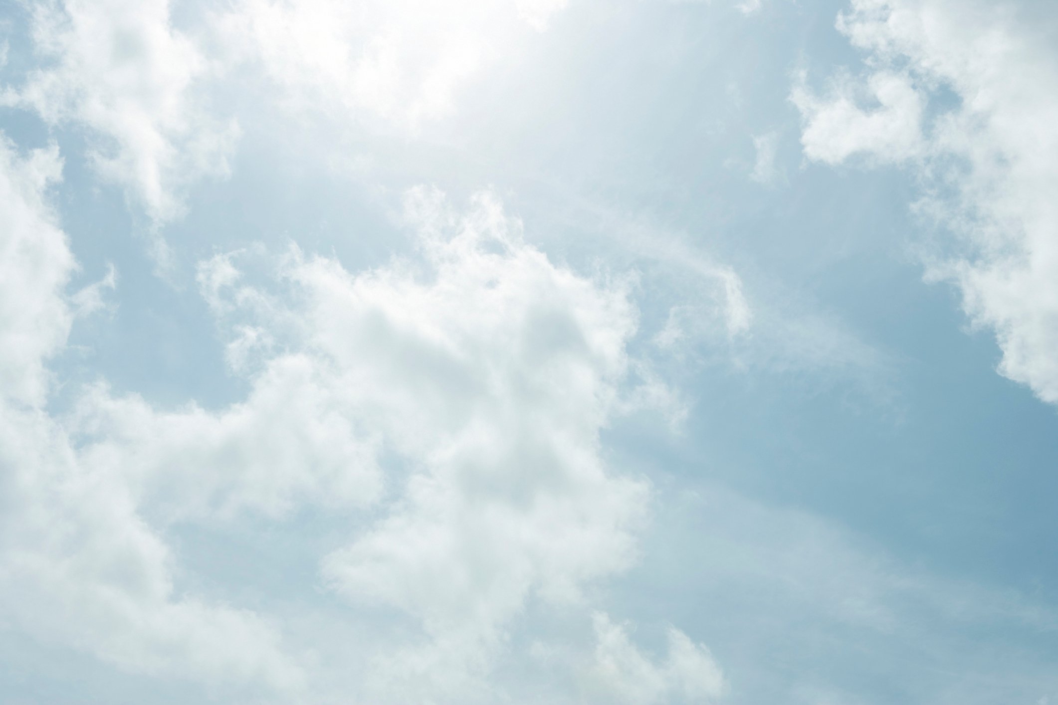 Picture of the sun shining through the clouds.