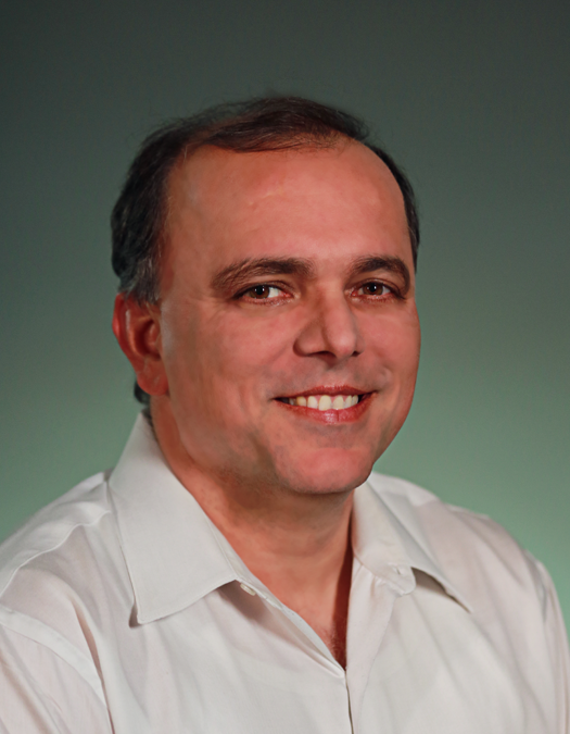 Limelight Networks' CFO, Sajid Malhotra,, smiling in front of a green color gradient.