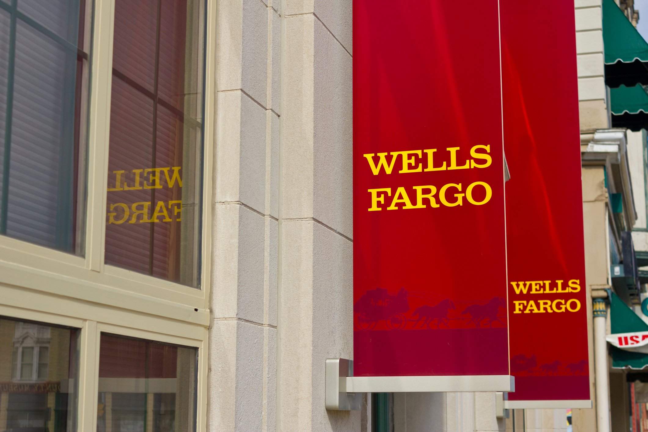 Red banners hanging outside a Wells Fargo branch.