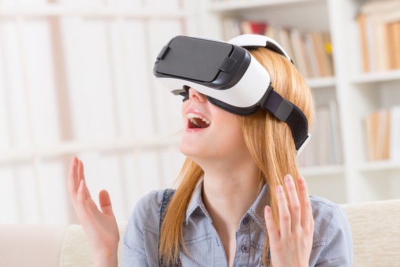 A woman uses a VR headset.