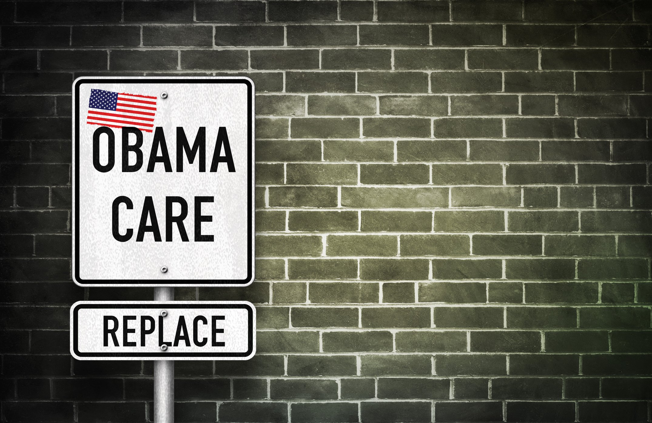 A street sign reading: "Obamacare, Replace," with an American flag on it