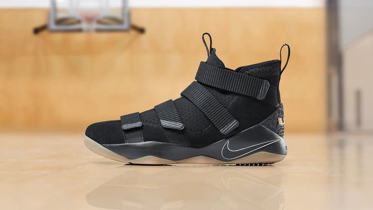 Close-up of a black basketball shoe on a hardwood floor