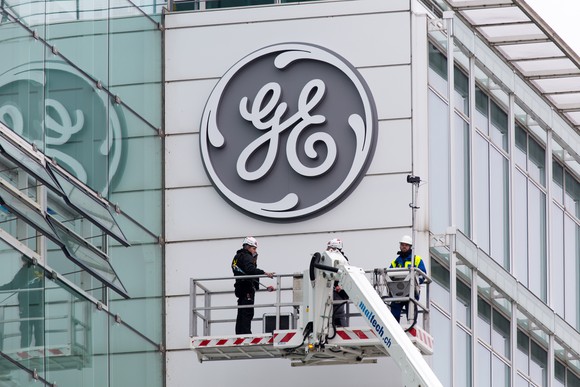 A GE logo being installed on a former Alstom building