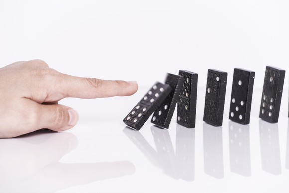 Dominoes being pushed over