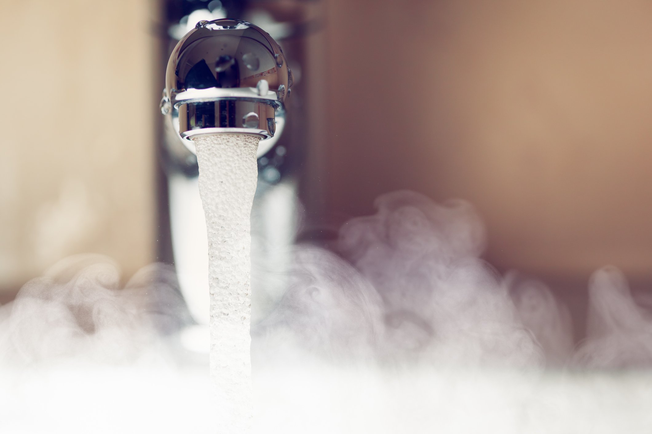 Hot water and steam coming from a faucet.