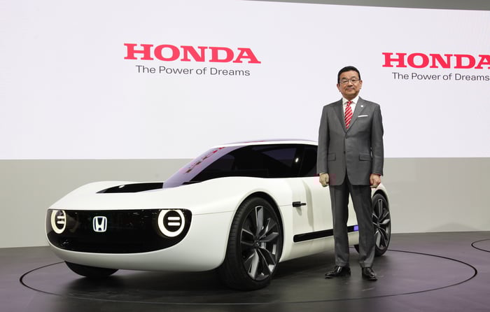 Hachigo is standing next to the Honda Sports EV Concept, a futuristic-looking curvy white coupe, on Honda's show stand at the Tokyo Motor Show on October 25, 2017.