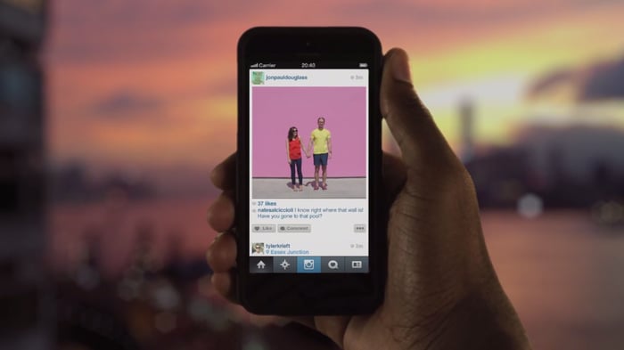 A person holding a phone with Instagram on it.