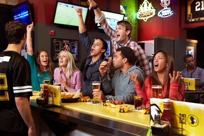 Diners cheering a game at a Buffalo Wild Wings bar