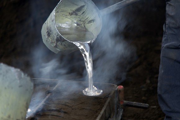 Molten aluminum being poured into a mold. 