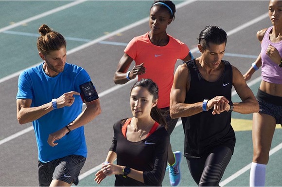 A group of runners on a track wearing Nike gear.