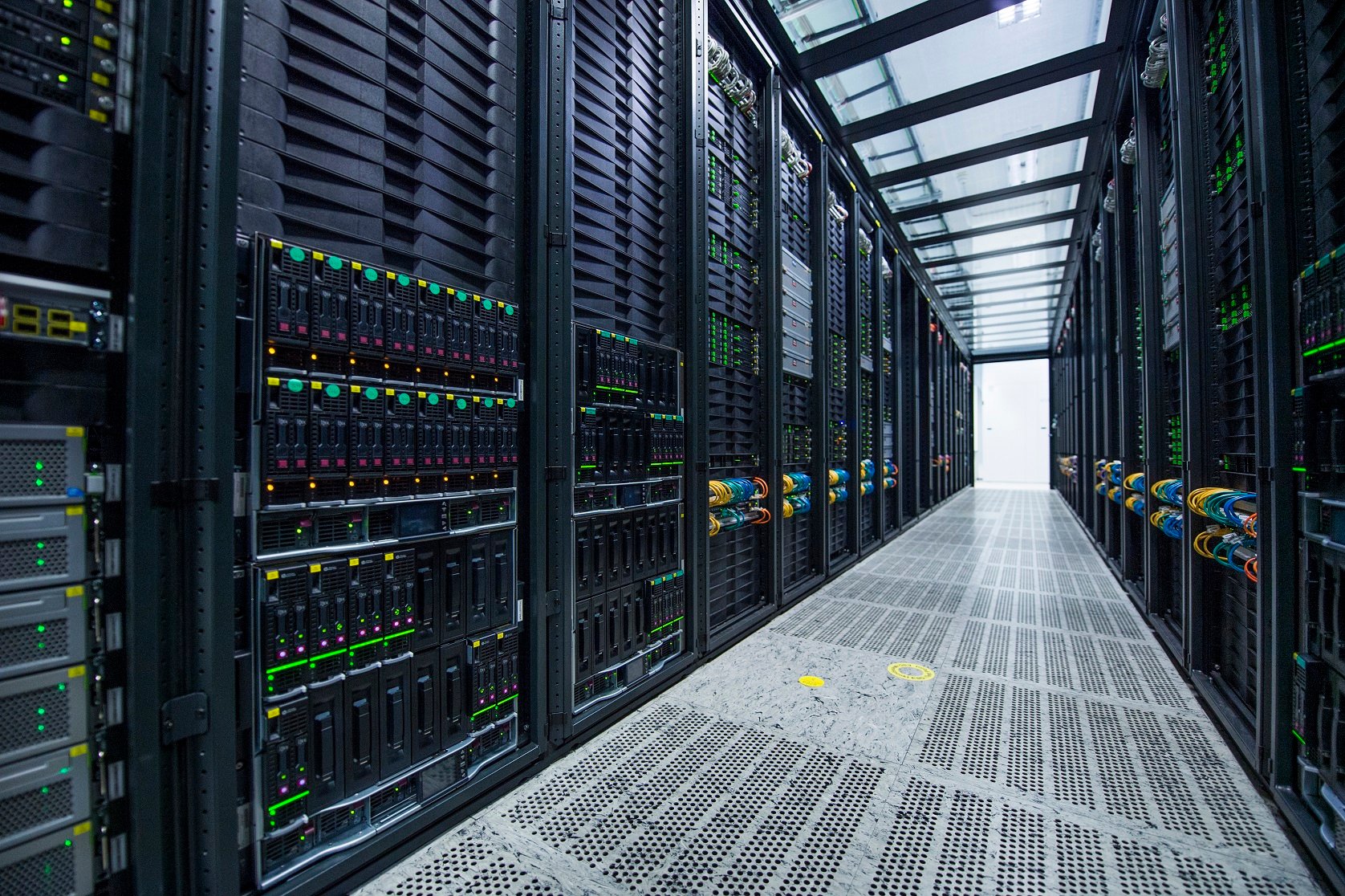 Row of Nokia servers on both sides of a clear aisle with metallic flooring.