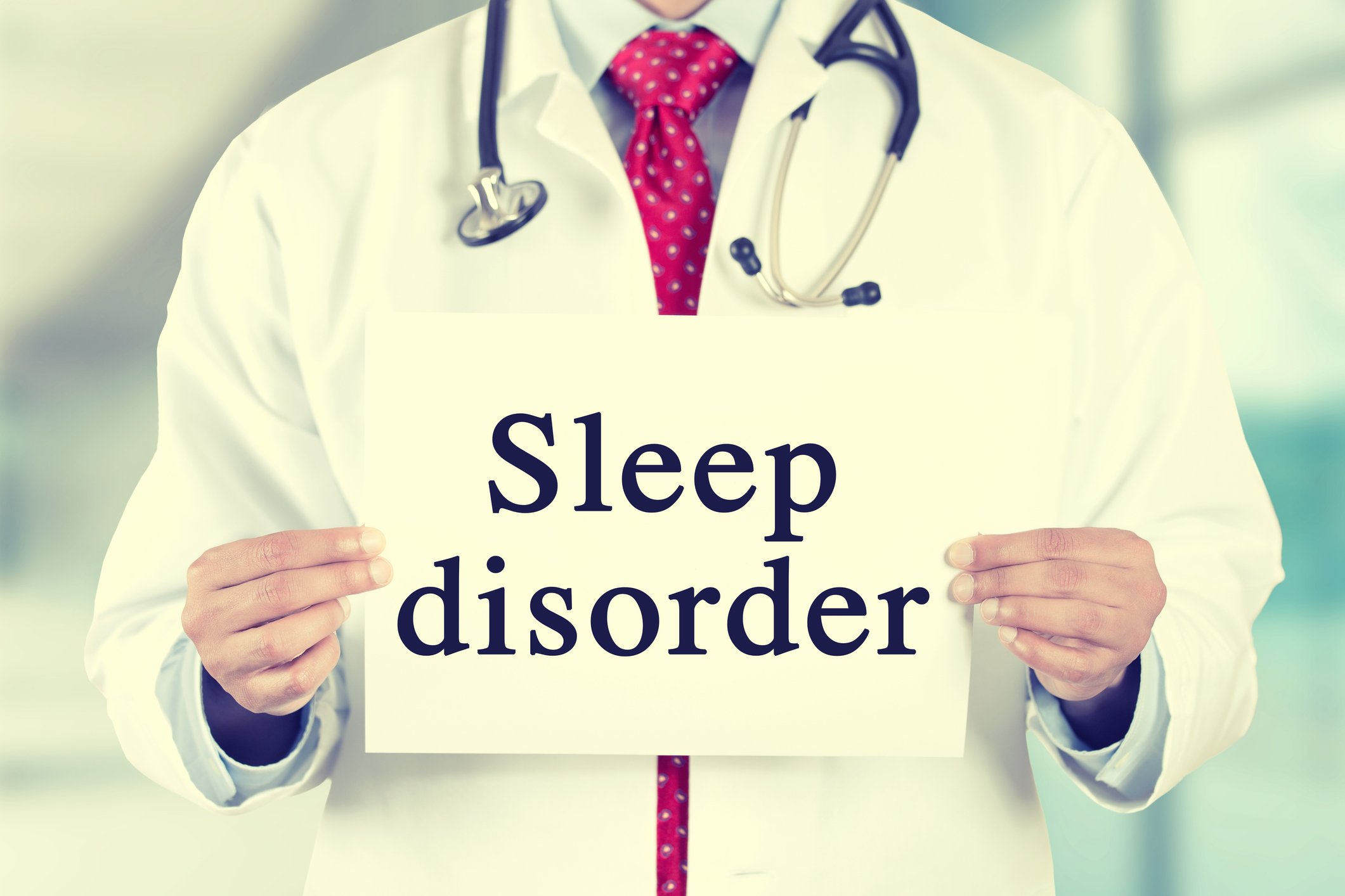 Doctor holding sign that says sleep disorder