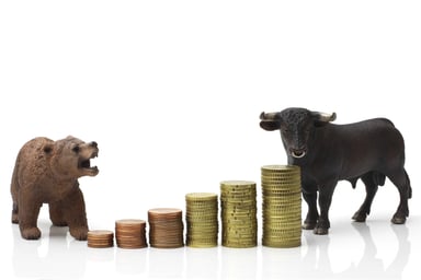 Bear and bull on stack of coins