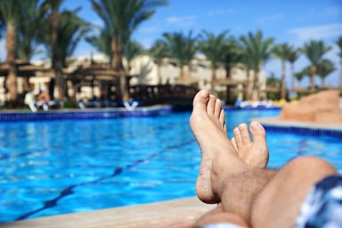 man's feet next to a pool_GettyImages-480582645