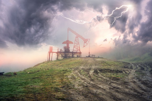 An oil pump with a storm overhead.