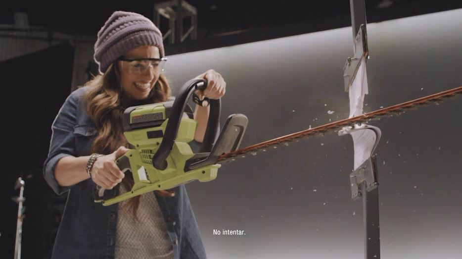 A woman with a power tool literally cutting her phone bill in half.