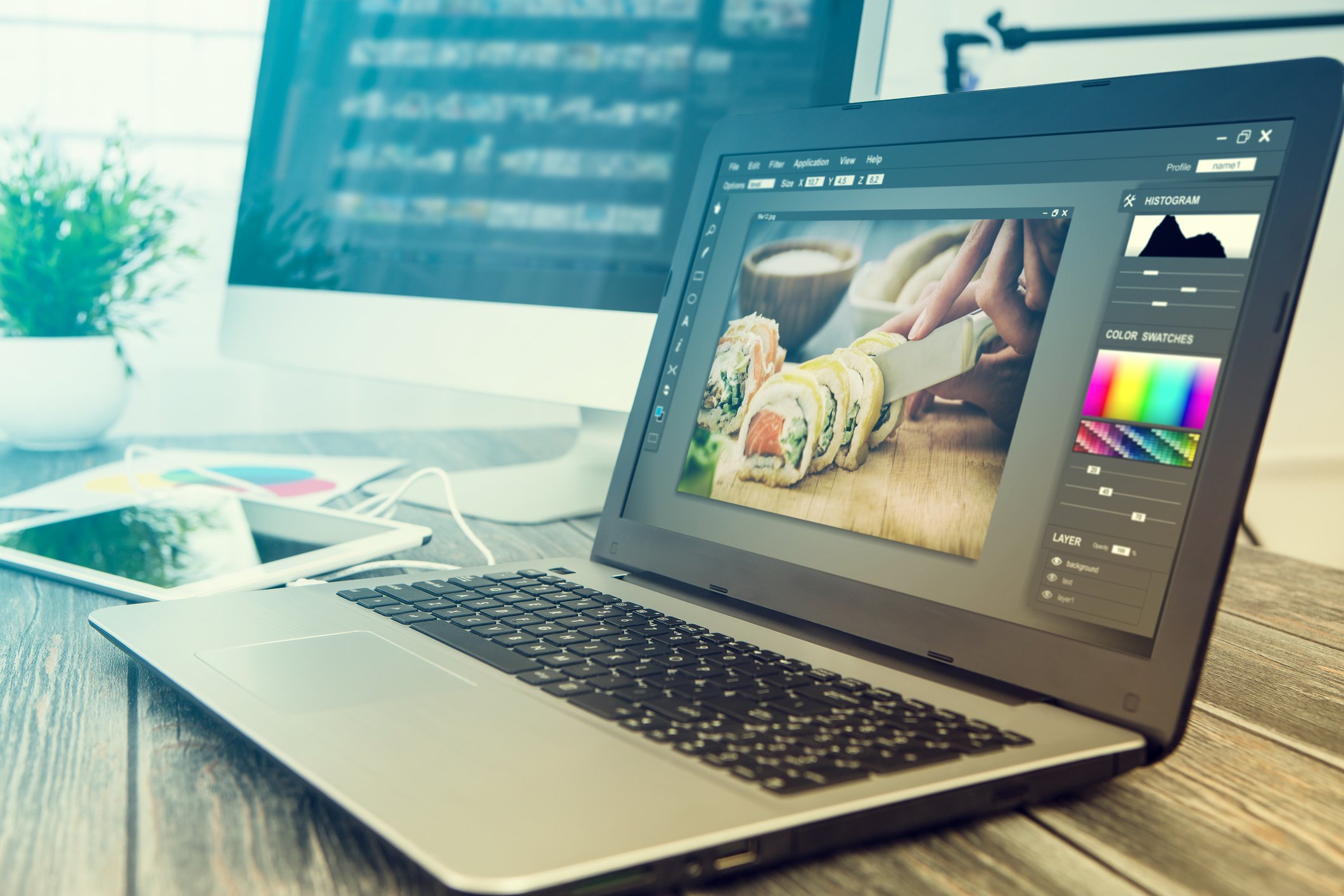 A laptop showing of sushi being cut