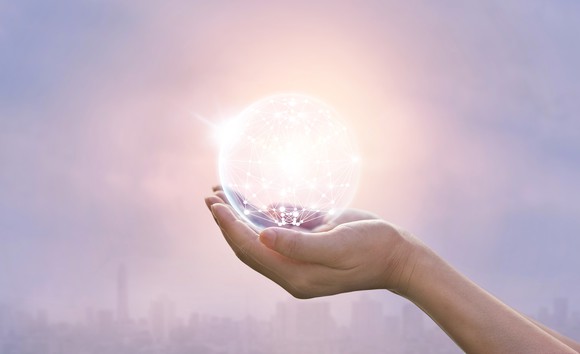 Palm holding glowing digital globe