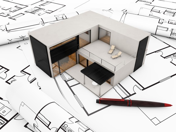 Modular building with computer-aided-design drawings around it. 