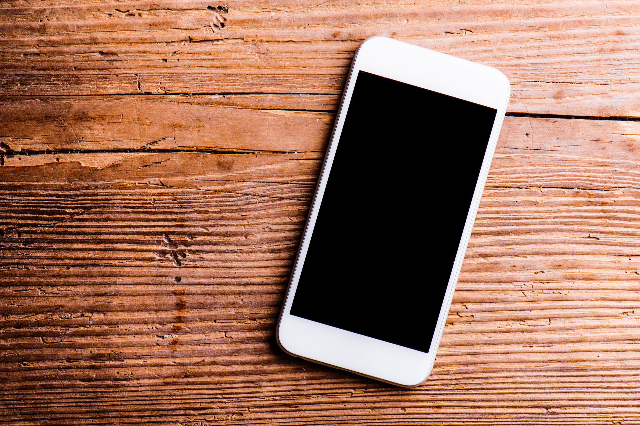 Smartphone sitting on wood table.