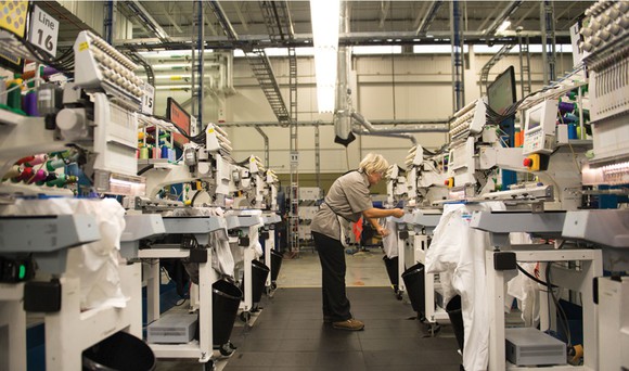 A worker adjusting Cimpress' mass-customization platform.