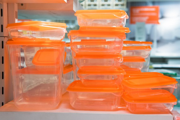 stacks of tupperware containers on a shelf