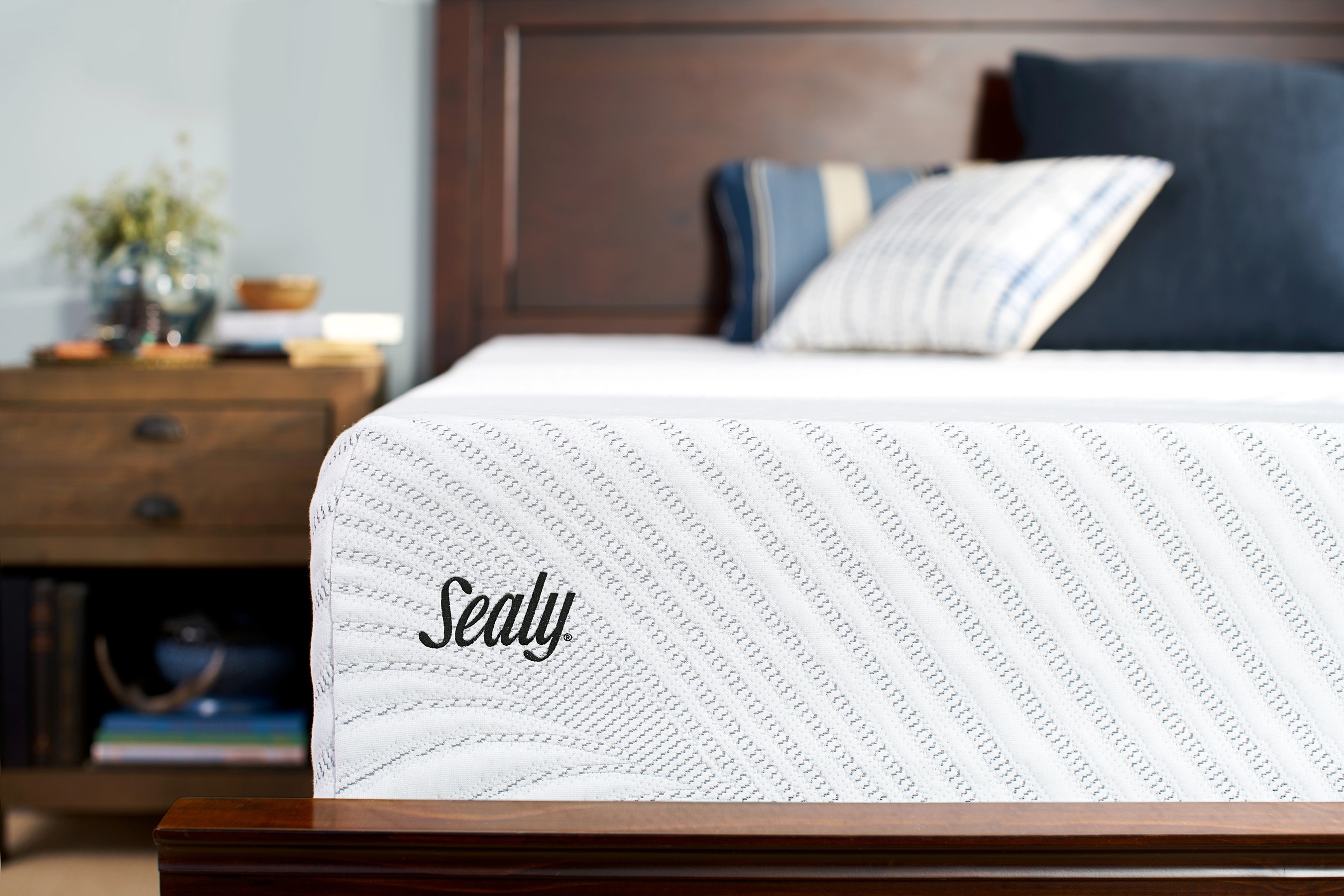 A Sealy-branded mattress in a bedroom