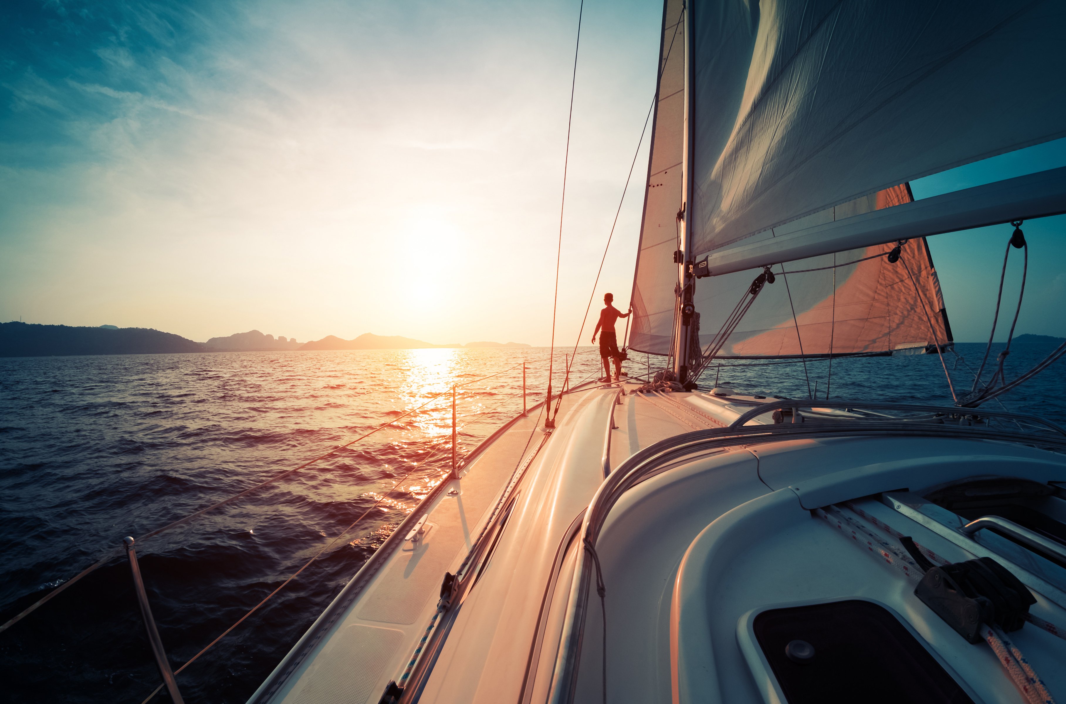 A sailboat pointing toward the sun
