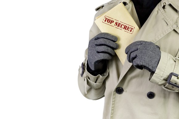 Man putting document marked Top Secret in his jacket