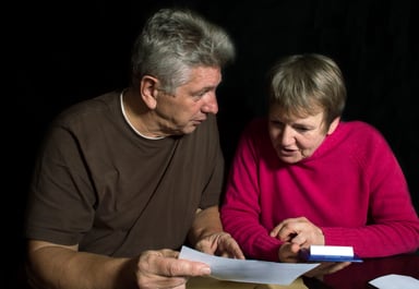 seniors looking at bills_GettyImages-467303398
