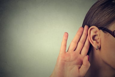 Woman with hand to ear