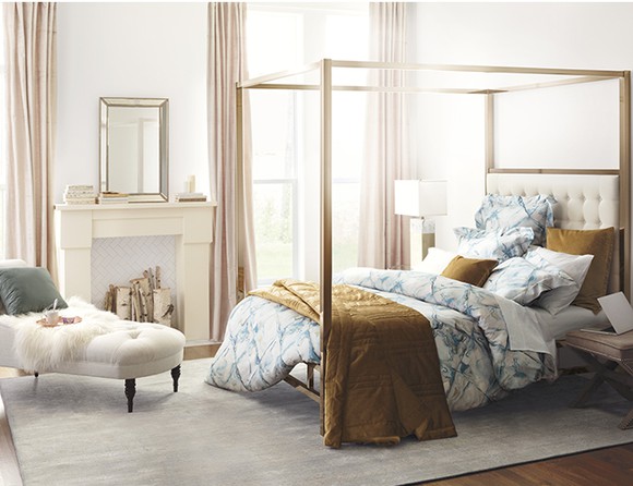 A bedroom set featuring a four-poster bed and a divan