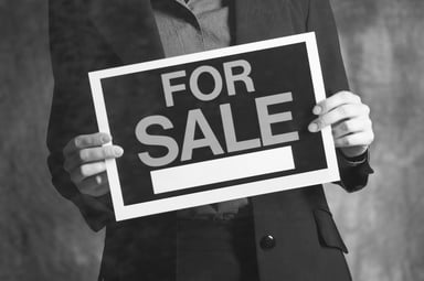 Man Holding For Sale Sign Buyout M&A Getty