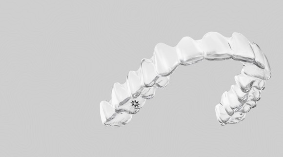 An Invisalign system against a gray background.
