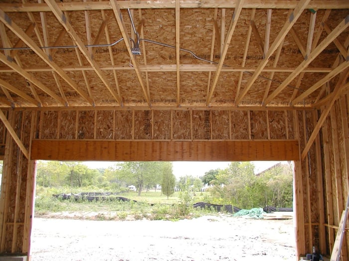 Garage frame showing wood beams and plywood used in construction.