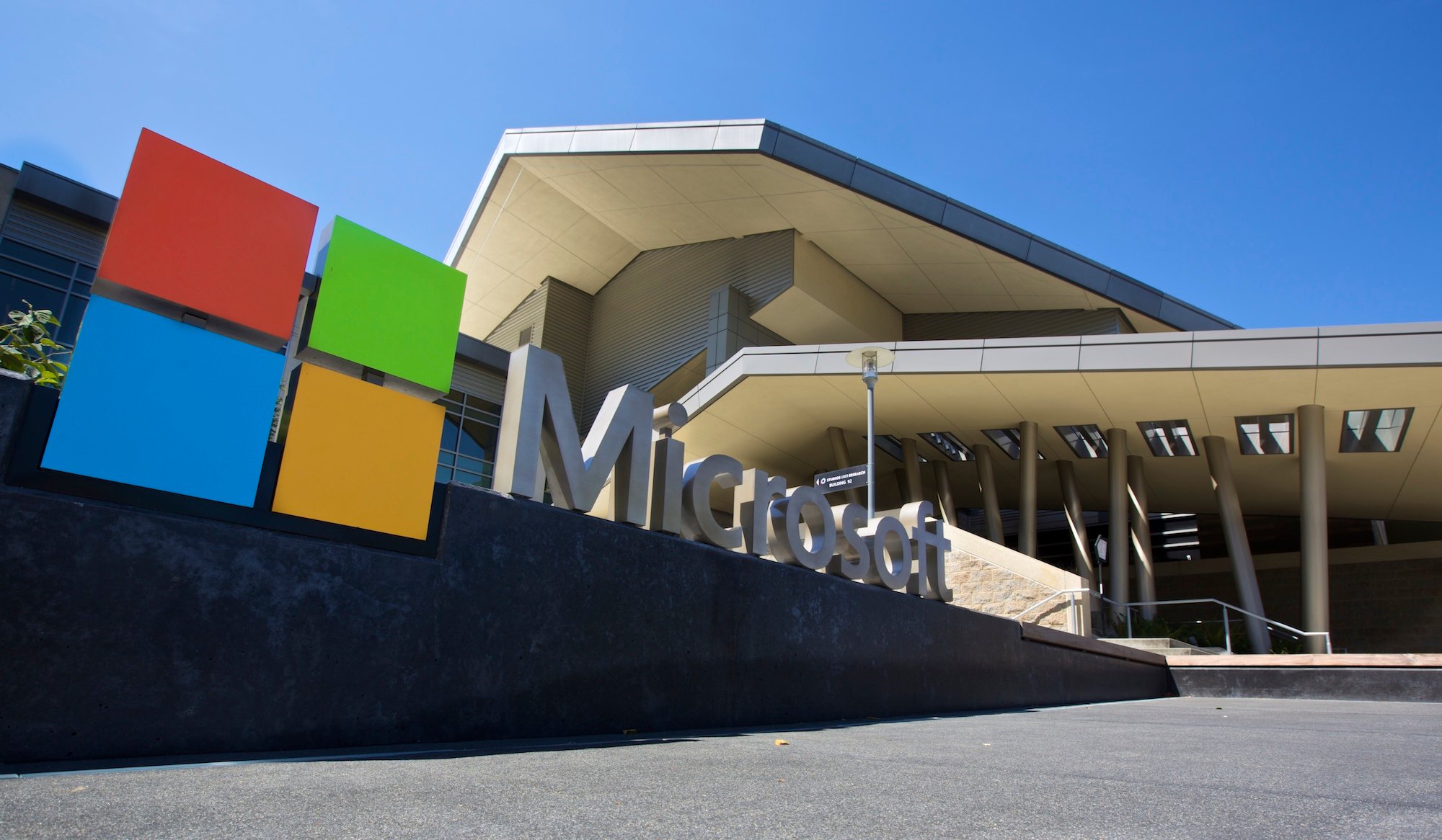 Picture of the outside of a Microsoft building with its logo in front.