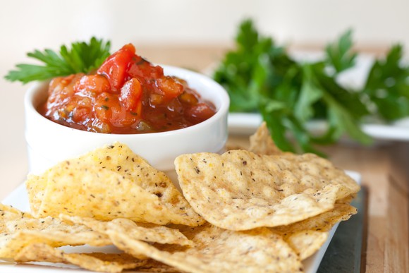 Chips next to a bowl of salsa