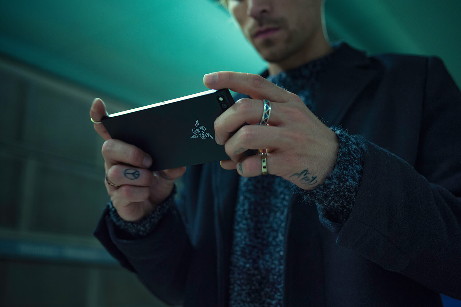A man holding and looking at the Razer Phone.