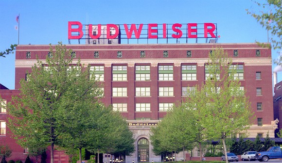 The front of a Budweiser factory, an old six-story brick building with the Budweiser name displayed on top.