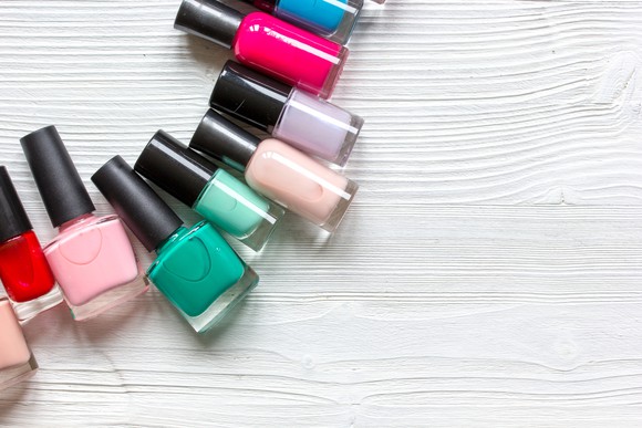 Nail polish containers on a wood table