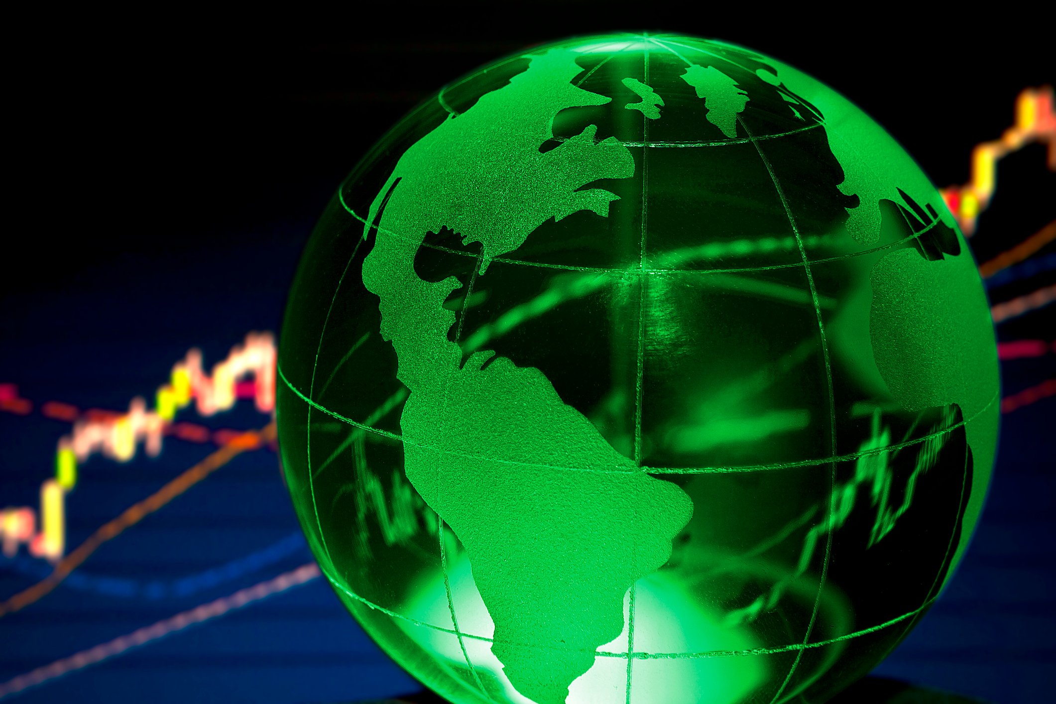 Green globe with stock chart in background